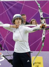 woman shooting arrow with bow